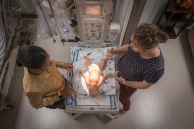 A student and a faculty member work in a simulation lab.