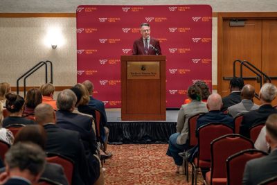 President Tim Sands speaks at a podium to a crowd