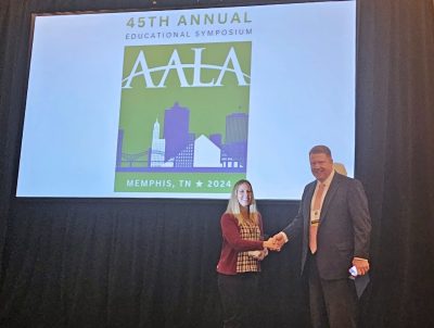 Jennifer Friedel receives the Excellence in Agricultural Law Award from John Dillard, USDA practice head at the law firm Olsson Frank Weeda Terman Matz PC, and a 2005 Department of Agricultural and Applied Economics alumnus. Photo courtesy of American Agricultural Law Association.