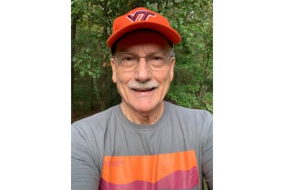 Headshot of man wearing Virginia Tech hat