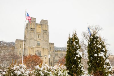 Snowy Burruss Hall with flag flying
