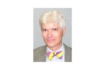 Headshot of male professor wearing bowtie and blazer.