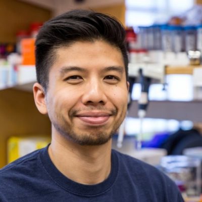 Headshot of Bryan Hsu standing in front of shelved chemicals