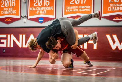 Mikey Harrigan wrestling another student in Hokie gym.