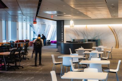 The learning commons area that features tables, chairs and large windows with a view of the Potomac.