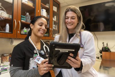 Stephanie DeMonaco (at right) working with 4th year DVM student Margarita Nevarez (at left) on a case in the Small Animal Internal Medicine wing at the Veterinary Teaching Hospital 