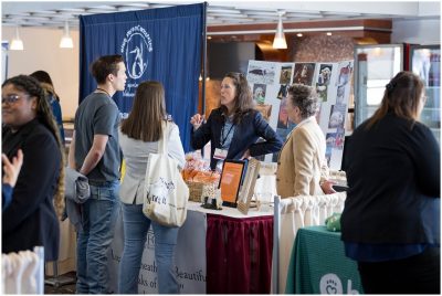 Four people (at center) gathered to hear a person (at center) speak about their business opportunities at the Veterinary Expo
