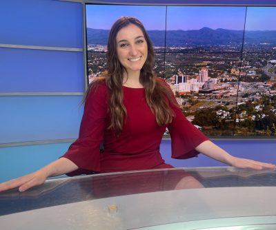 Photo of Lindsey Cook sitting behind achor's desk at WDBJ7 studio